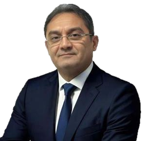 Portrait of Yasser Attia in a navy suit and tie.